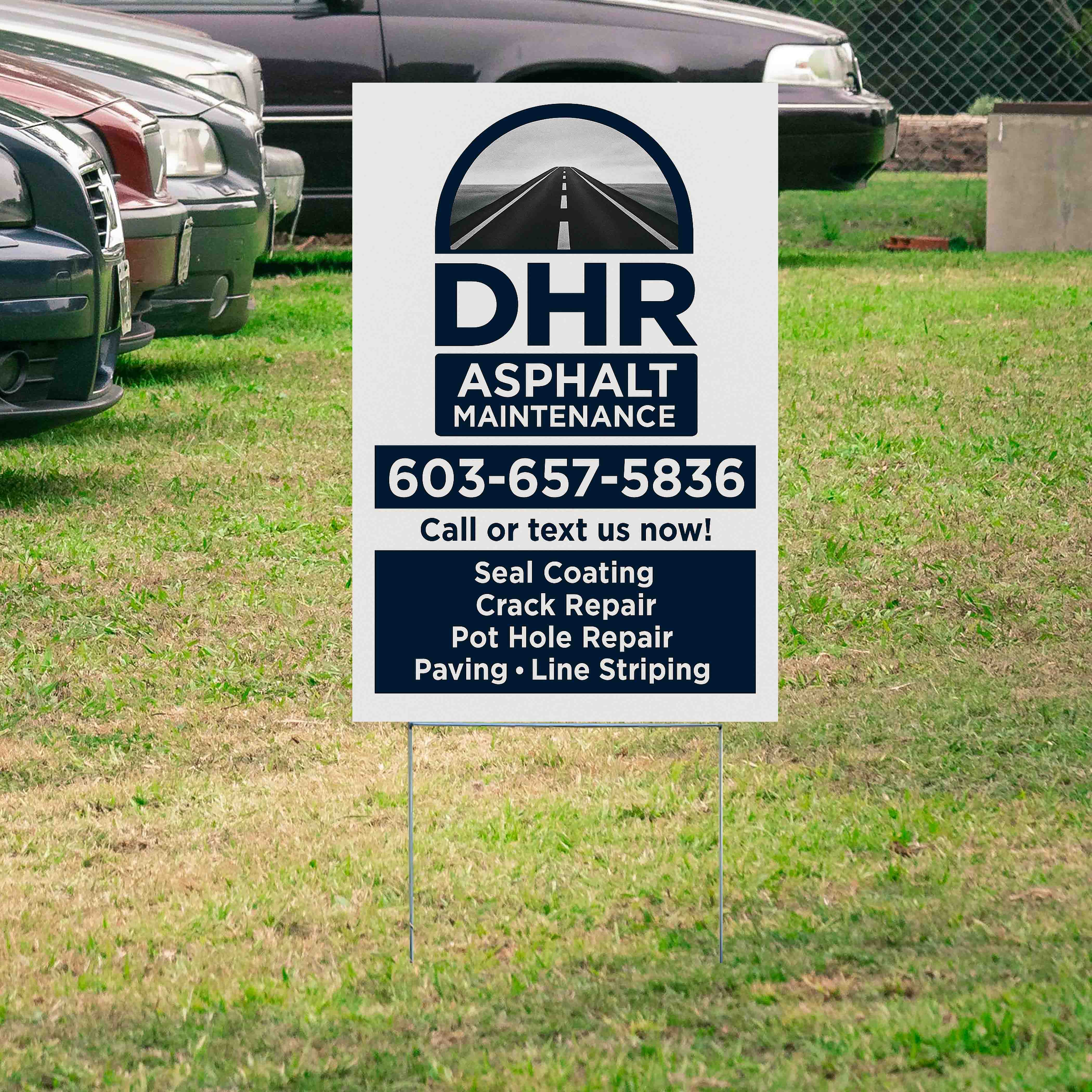 Lawn sign advertising DHR Asphalt Maintenance with contact number 603-657-5836, offering services like seal coating, crack repair, pothole repair, paving, and line striping, placed next to parked cars on grass.