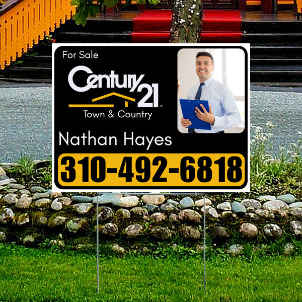 Real estate for sale sign on lawn, featuring agent photo, Century 21 Town & Country logo, agent name Nathan Hayes, and contact number 310-492-6818.