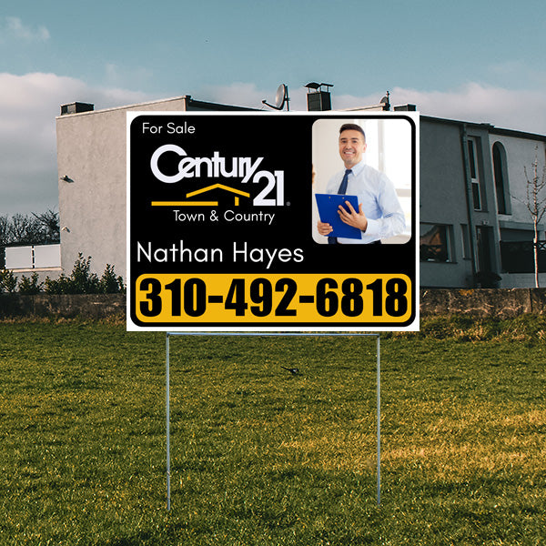 Real estate sign for sale from Century 21 Town & Country with contact information for agent Nathan Hayes and phone number 310-492-6818, placed in front of a modern house.