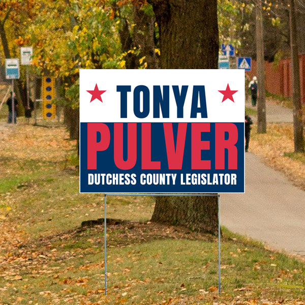 Campaign sign for Tonya Pulver, Dutchess County Legislator, placed on a grassy area beside a tree in an autumn setting.