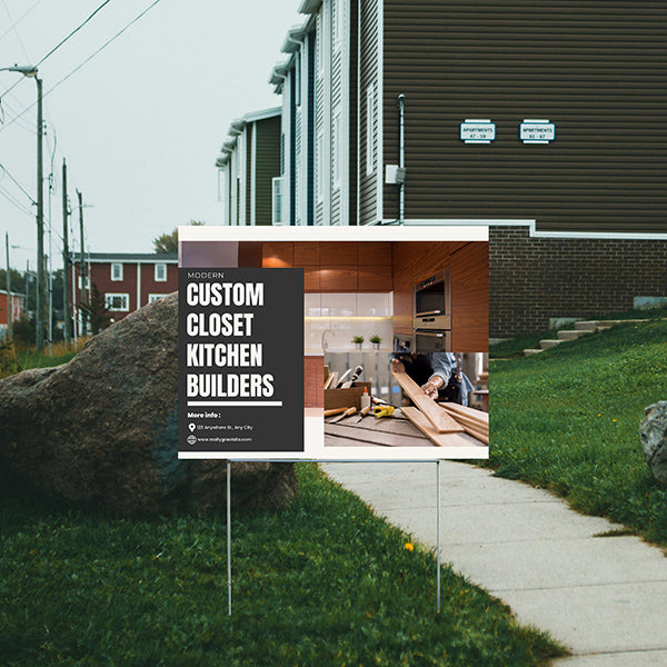 Yard sign promoting modern custom closet and kitchen builders in a residential neighborhood.
