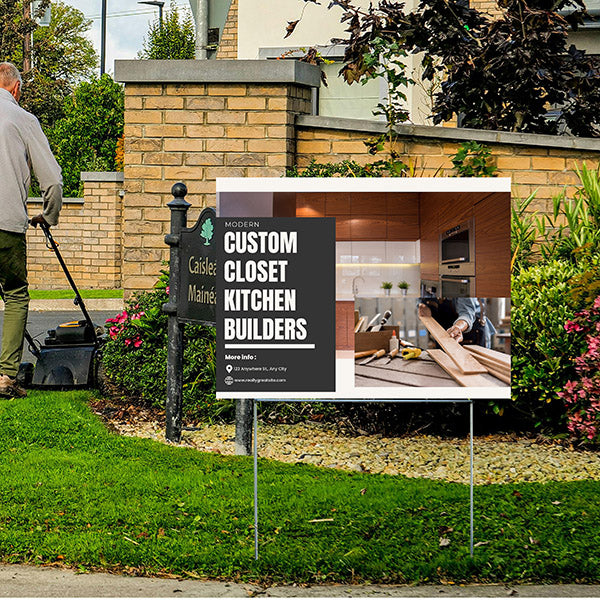 Man mowing lawn near custom closet kitchen builders advertisement sign in a residential neighborhood.