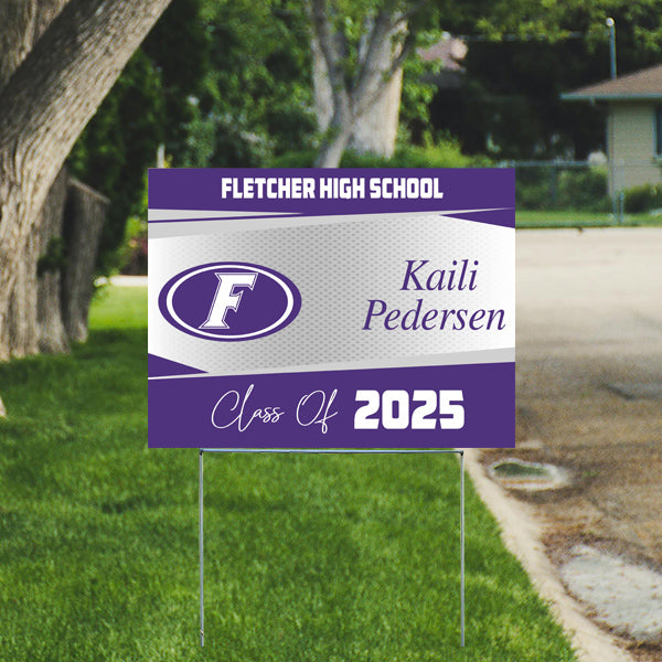 Fletcher High School yard sign with the name Kaili Pedersen, Class of 2025, featuring a purple and white design, displayed on a grassy area.