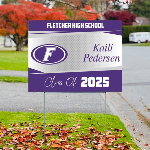 Fletcher High School graduation sign for Kaili Pedersen, Class of 2025, displayed outdoors with autumn leaves.