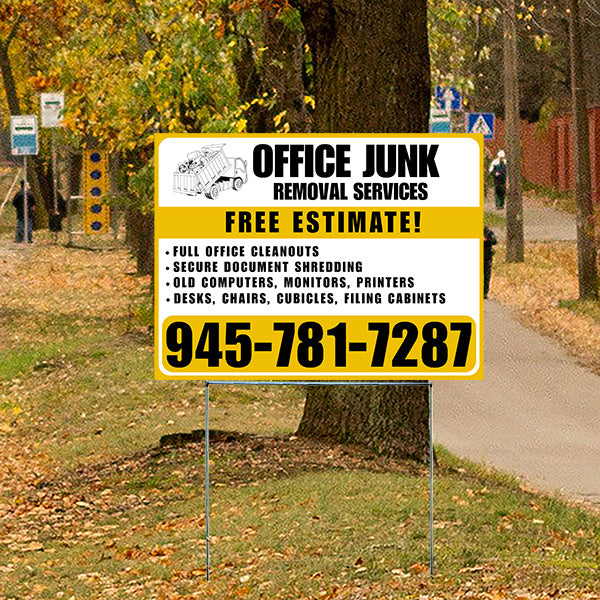 Sign for Office Junk Removal Services with contact number 945-781-7287, offering full office cleanouts, secure document shredding, disposal of old computers, monitors, printers, desks, chairs, cubicles, and filing cabinets, on a grassy roadside with autumn leaves.
