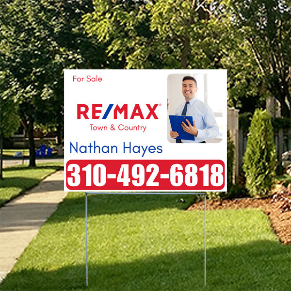 Real estate for sale sign in yard featuring RE/MAX Town & Country branding, contact information for Nathan Hayes, and phone number 310-492-6818.