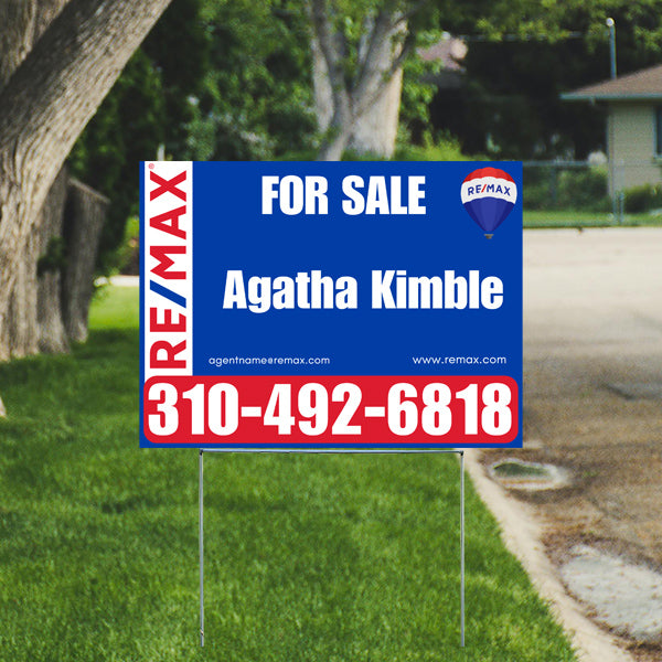 Real estate sign for sale by RE/MAX with agent contact number 310-492-6818 displayed on a residential lawn.