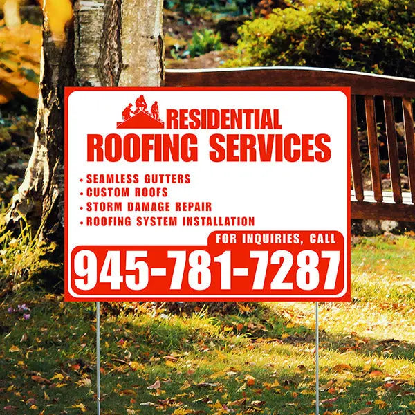 Residential roofing services sign with contact information in a garden setting