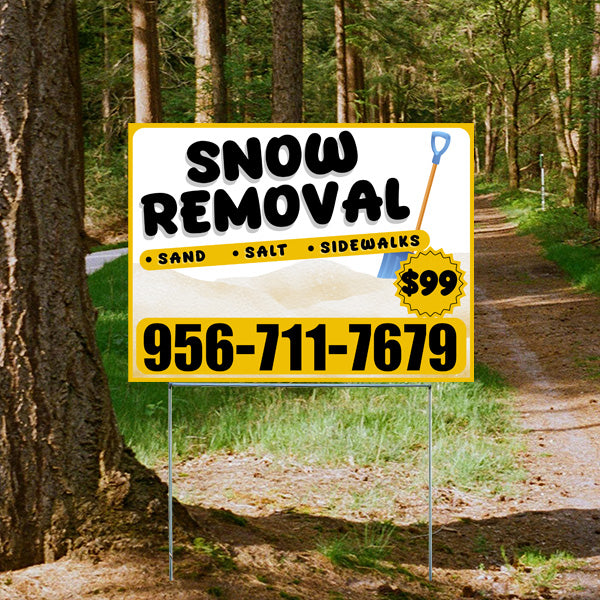 Sign advertising snow removal services with price and contact number, placed on a forest path.