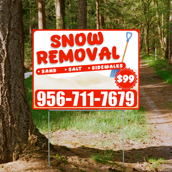 Snow removal services sign with contact number and $99 promotion surrounded by trees and a pathway in the background.