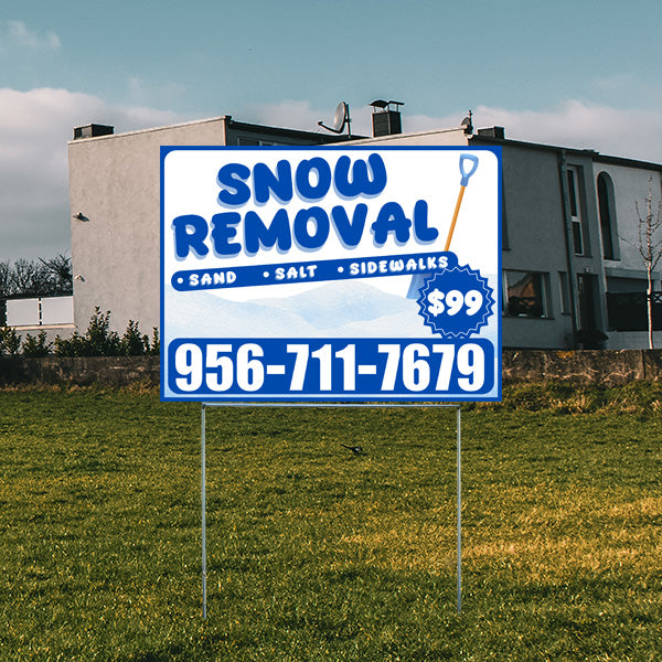 Outdoor yard sign advertising snow removal services, featuring the text sand, salt, sidewalks, and a phone number 956-711-7679 for $99, with a residential house in the background.