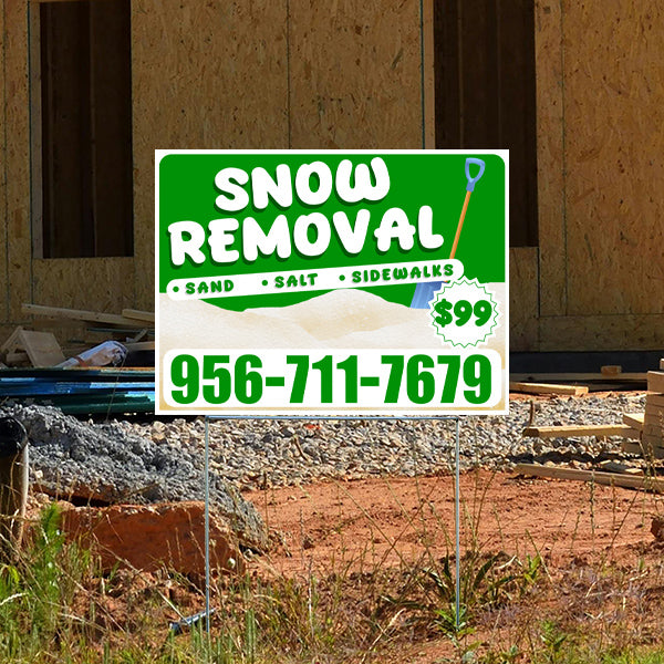 Snow removal service sign with contact number 956-711-7679, offering sand, salt, and sidewalk services for $99, displayed on a construction site background.