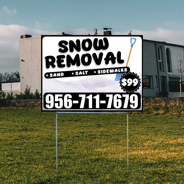 Snow removal sign with contact number 956-711-7679 offering services for sand, salt, and sidewalks priced at $99, displayed in front of a modern house.