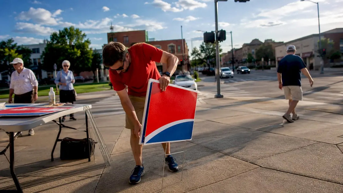 Volunteer installing campaign sign outdoors