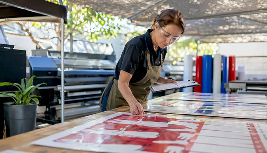 Print manager inspecting freshly printed vinyl signs