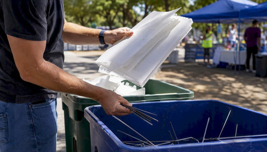 Hands separating yard sign panels and metal stakes