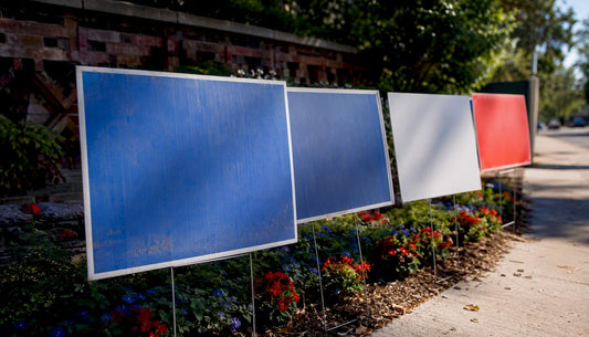 Faded and vibrant yard signs on lawn