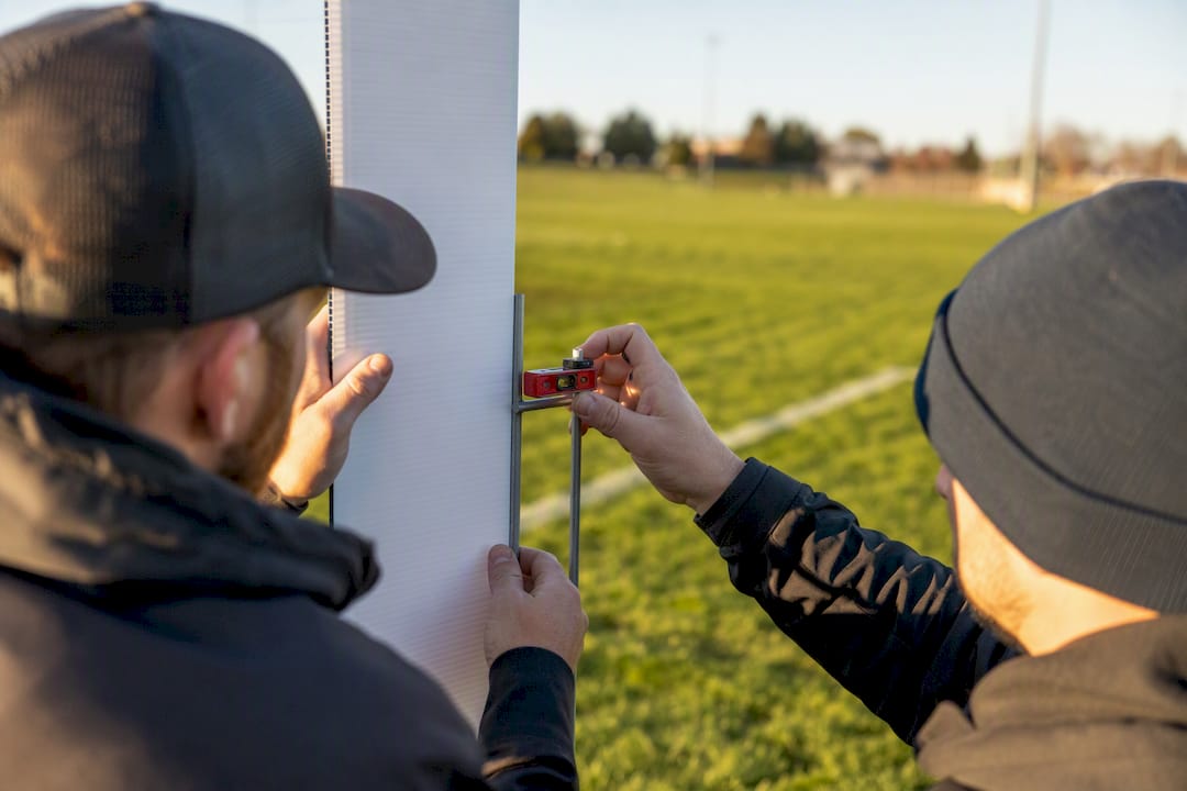 Crew checking yard sign stake alignment