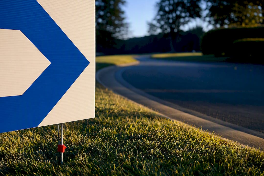 Cropped directional sign beside venue drive
