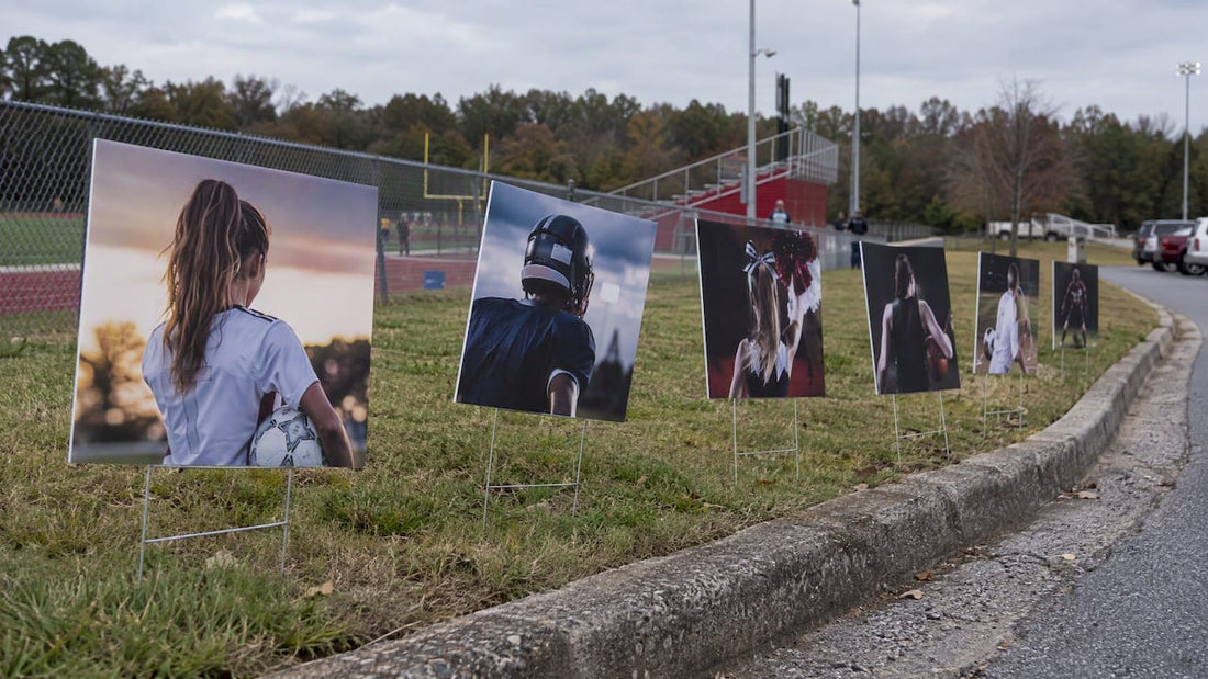 Senior night yard signs beside athletic field