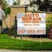 S-yard sign for auto repair services and window tinting with a phone number, placed in front of a house.