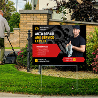 Outdoor sign for an auto repair company with a man in the background mowing grass.