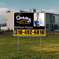 Real estate sign for sale from Century 21 Town & Country with contact information for agent Nathan Hayes and phone number 310-492-6818, placed in front of a modern house.