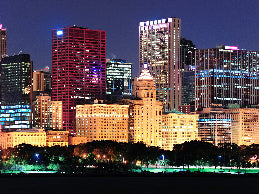 City skyline at night with illuminated buildings