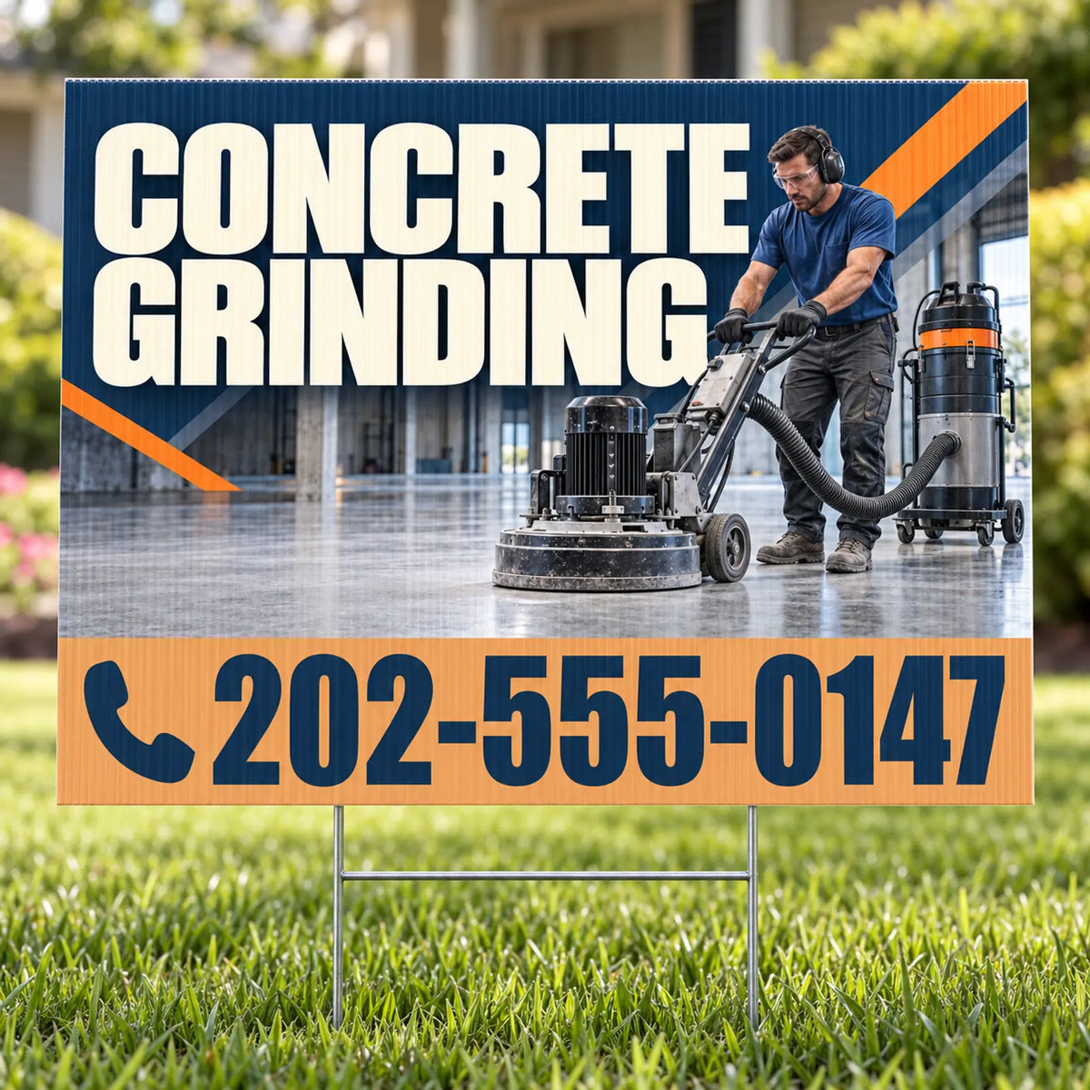 A yard sign on a lawn advertising concrete grinding services, with a photo of a worker operating a floor grinder and a large phone number at the bottom.