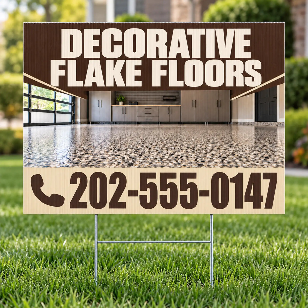 A yard sign on metal stakes displayed in a grassy lawn. The sign features a brown and beige design with the text 'DECORATIVE FLAKE FLOORS' and a phone number, with a photo of a polished concrete floor in the background.