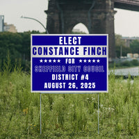 Campaign sign for Constance Finch running for Sheffield City Council, District 4, election date August 26, 2025, placed in a grassy area with a bridge in the background.