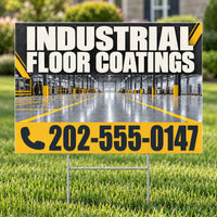 A yard sign on metal stakes displaying 'INDUSTRIAL FLOOR COATINGS' with a large phone number, set in a grassy outdoor area with a blurred industrial warehouse background.