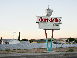 Vintage sign for 'dari delite' on a clear day with minimal background