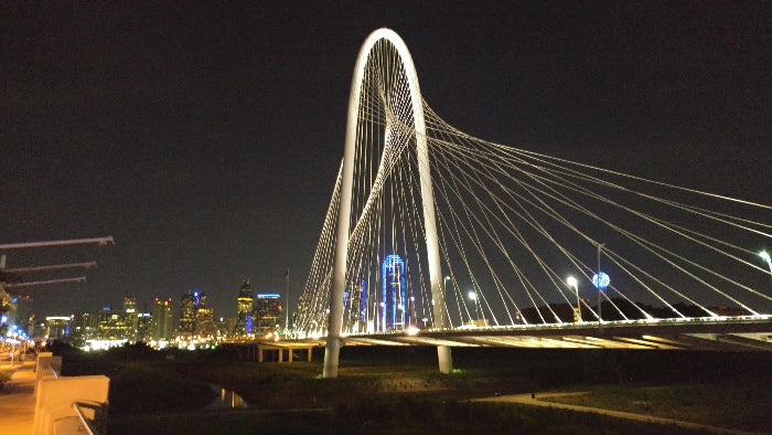  illuminated bridge over a cityscape at night