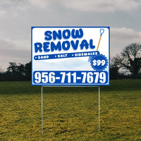 Outdoor sign advertising snow removal services with contact number 956-711-7679 and price of $99, offering sand, salt, and sidewalk clearing.