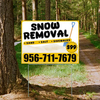 Sign advertising snow removal services with price and contact number, placed on a forest path.