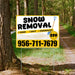 Sign advertising snow removal services with price and contact number, placed on a forest path.
