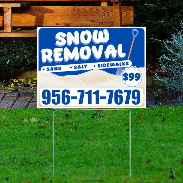 Yard sign advertising snow removal services with phone number 956-711-7679 offering sand, salt, and sidewalk clearing for $99.